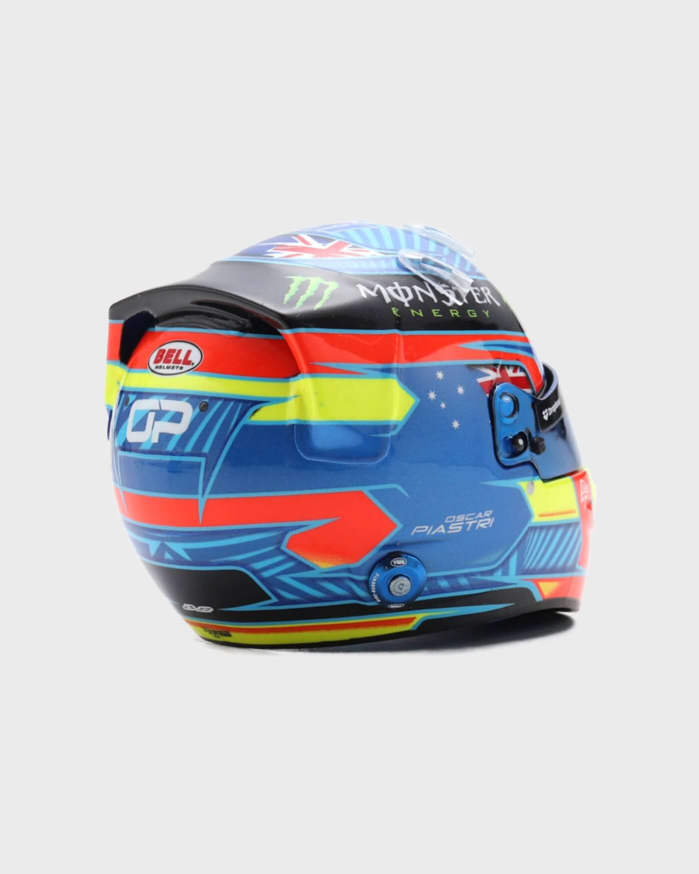 1:5 scale 2024 Oscar Piastri F1 helmet replica by Spark, featuring red, blue, yellow design, personal logo, and Australian flag.