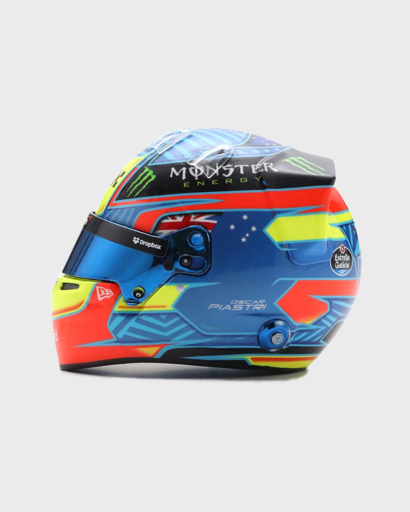 1:5 scale 2024 Oscar Piastri helmet with red, blue, yellow design by Spark, featuring racing number and personal logo.