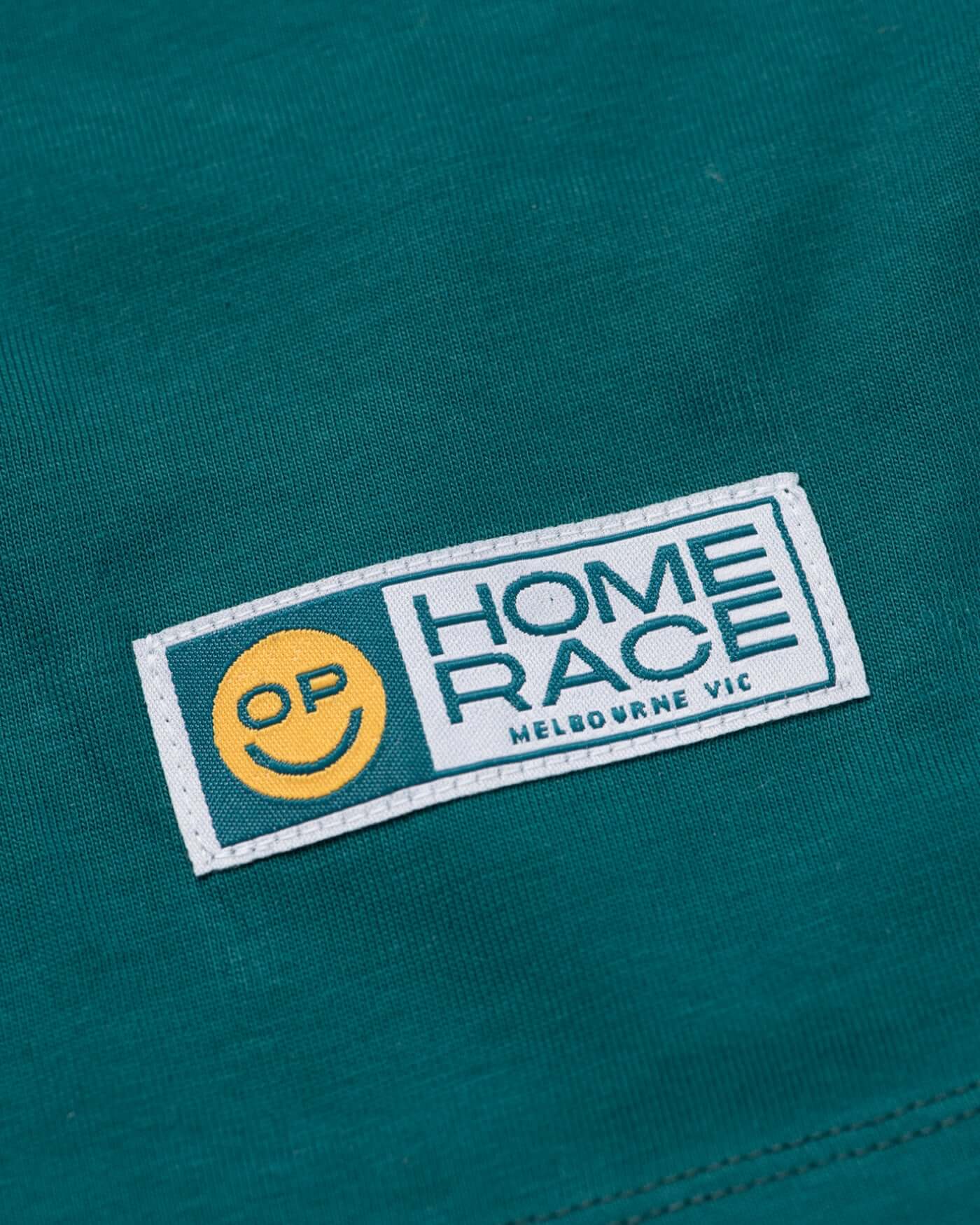 Home Race '26 T-Shirt - Green logo patch featuring OP smiley design and Melbourne VIC text