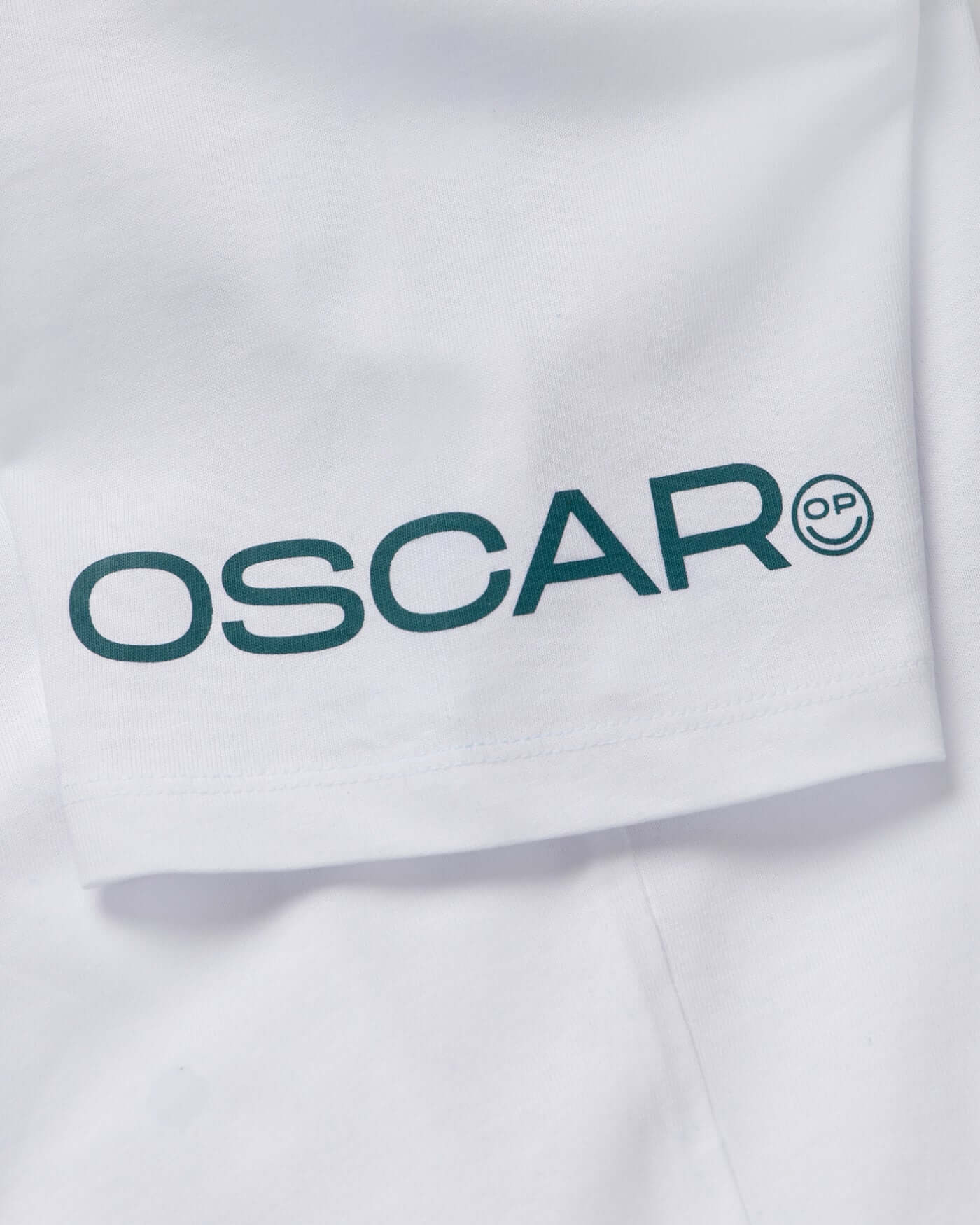 Close-up of the Oscar Piastri logo on the Home Race '26 T-Shirt - White, showcasing its stylish design.