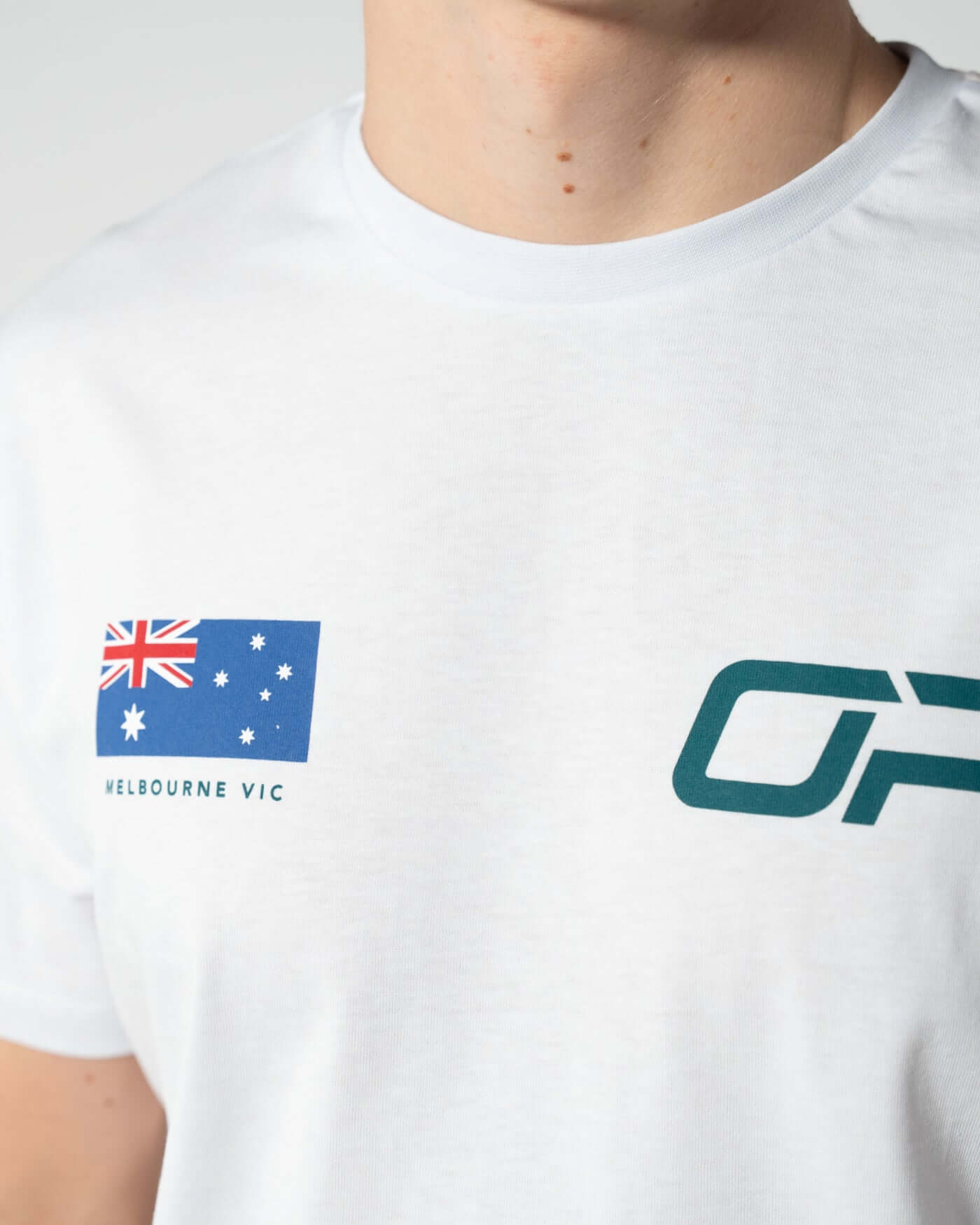 Home Race '26 T-Shirt - White close-up featuring Australian flag and OP logo detail.