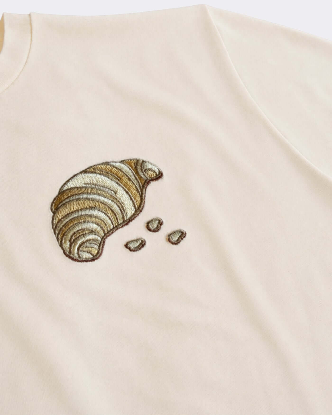 The Pastry Piastee t-shirt featuring a ribbed neckline and embroidered pastry design.