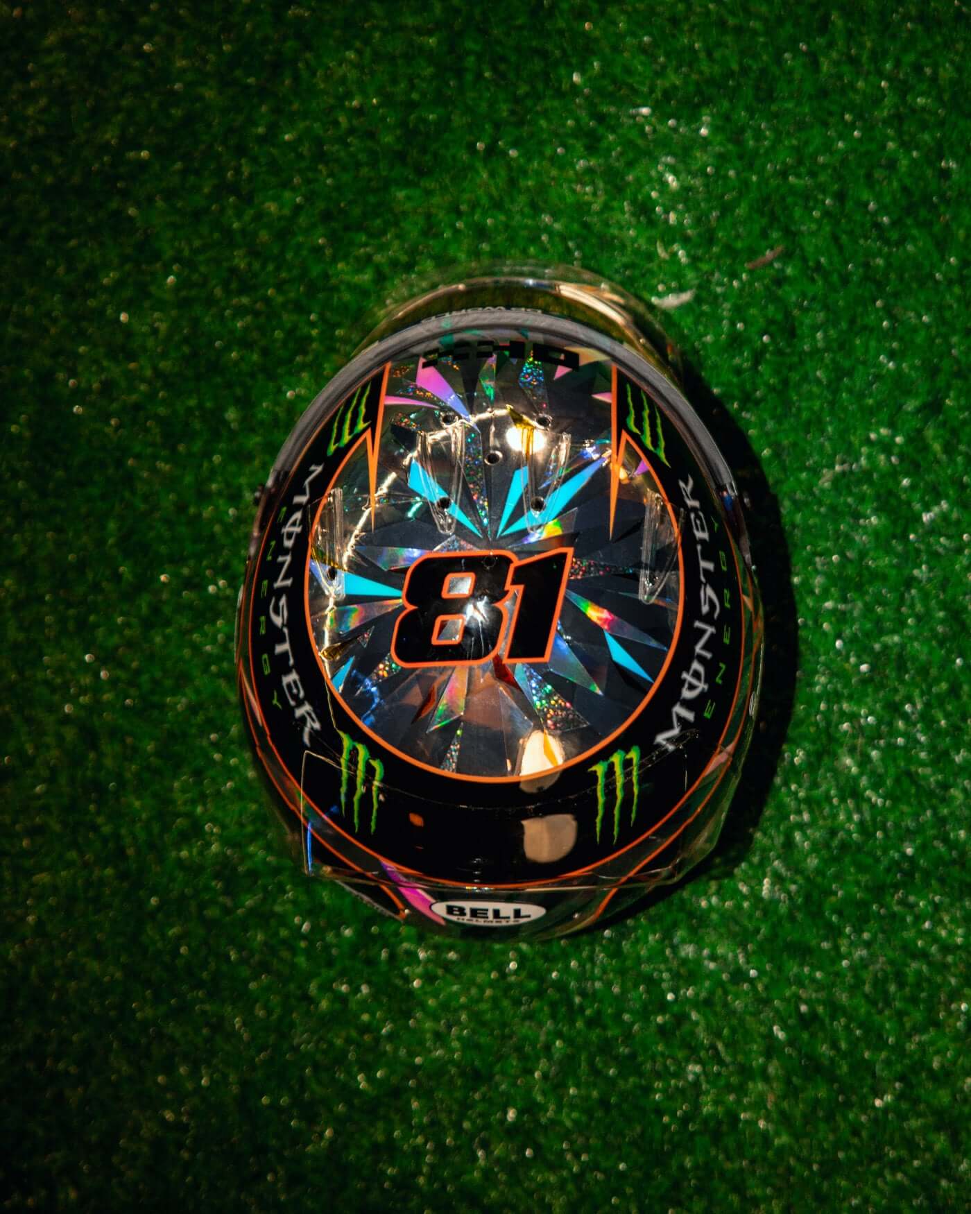 1:2 scale 2024 Singapore racing helmet replica of Oscar Piastri with Bell branding on green grass display.