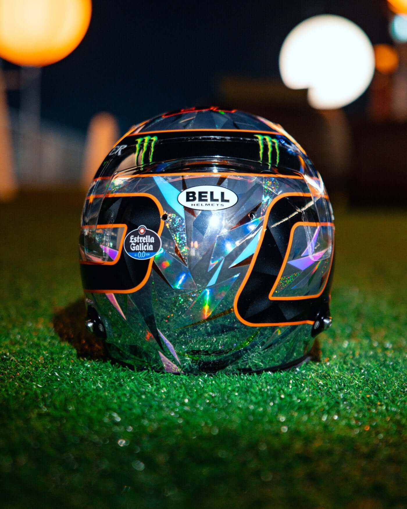 1:2 scale replica of Oscar Piastri's 2024 Singapore Grand Prix helmet by Bell on grass with detailed design and sponsor logos