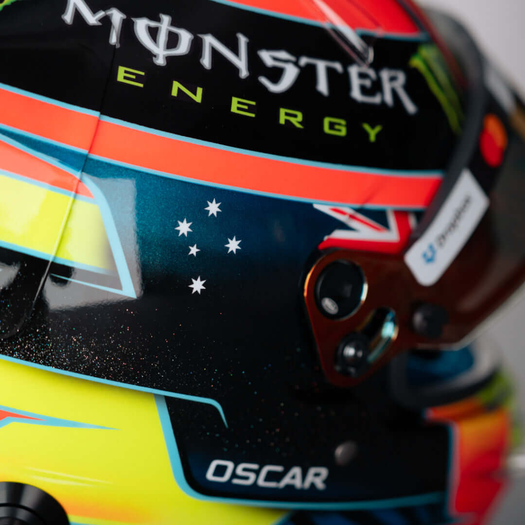 Close-up of a colorful racing helmet featuring Monster Energy logo and Australian flag design.
