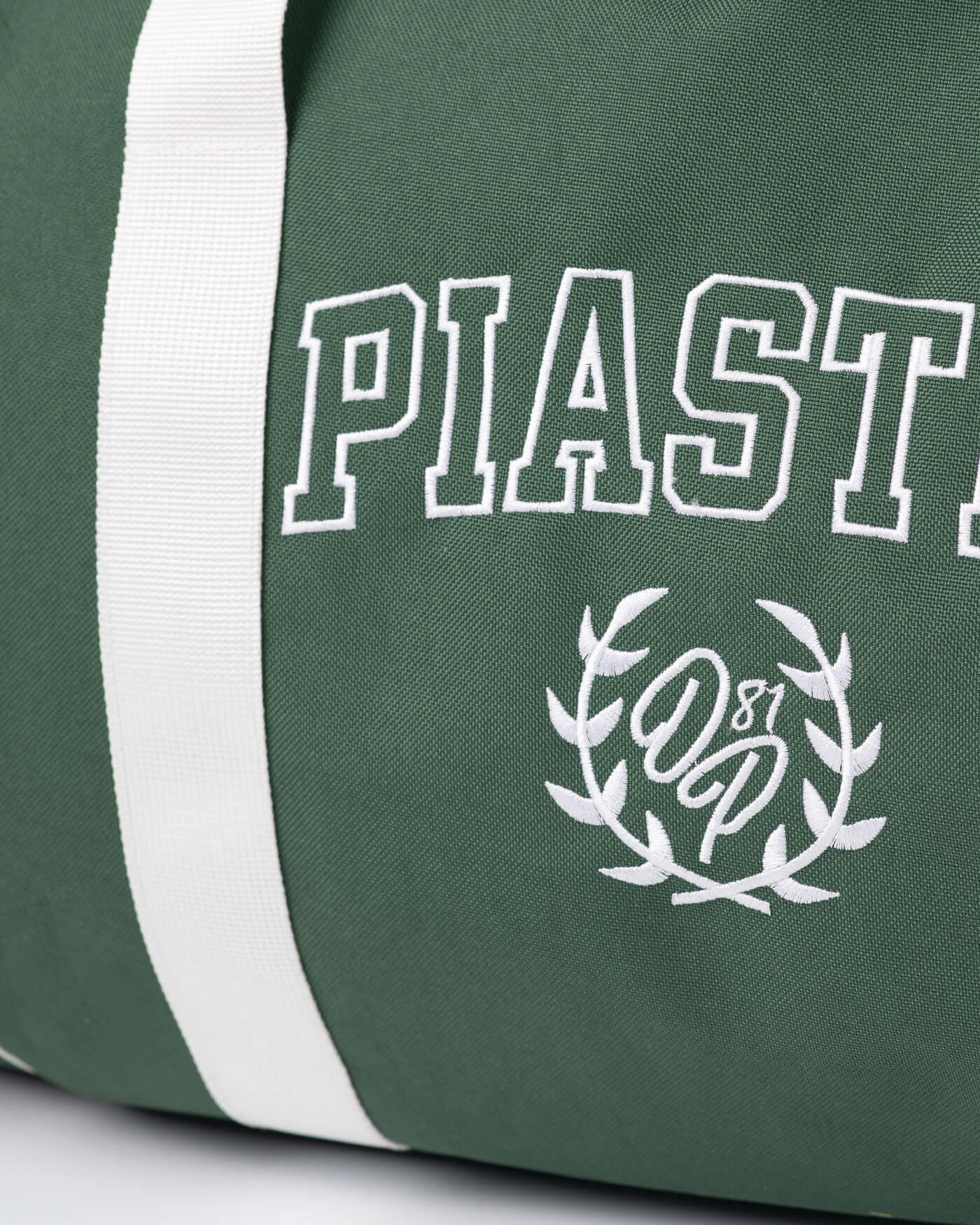 Close-up of the green Home Race Barrel Bag featuring white logo and stripes, perfect for on-the-go adventures.