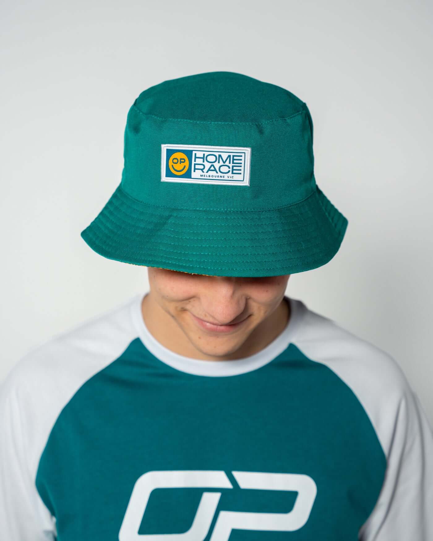 Oscar Piastri wearing the Home Race '26 Bucket Hat in iconic Aussie green and gold.