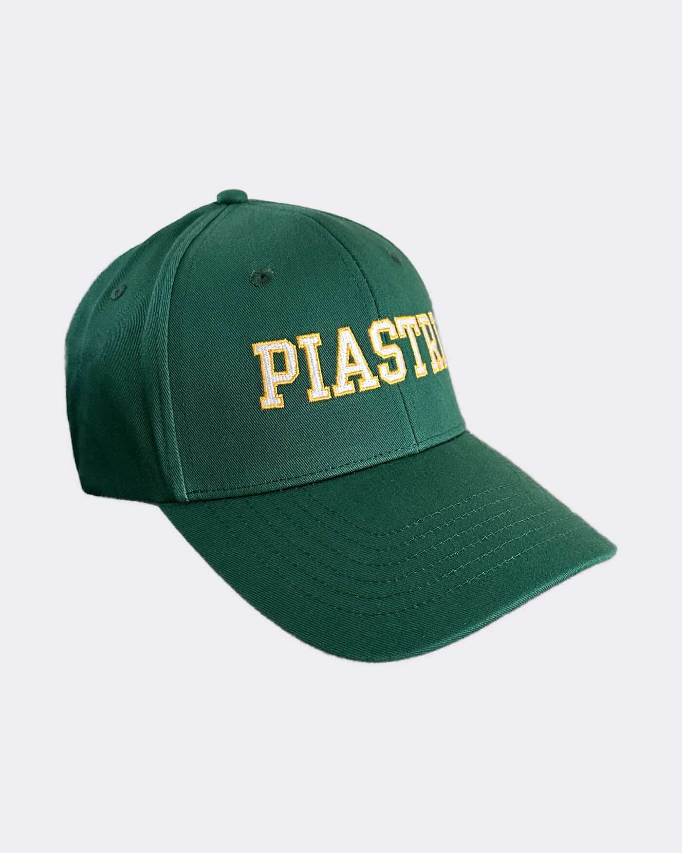 Green cap with yellow "PIASTRA" embroidery, part of the exclusive Victory Bundle collection.