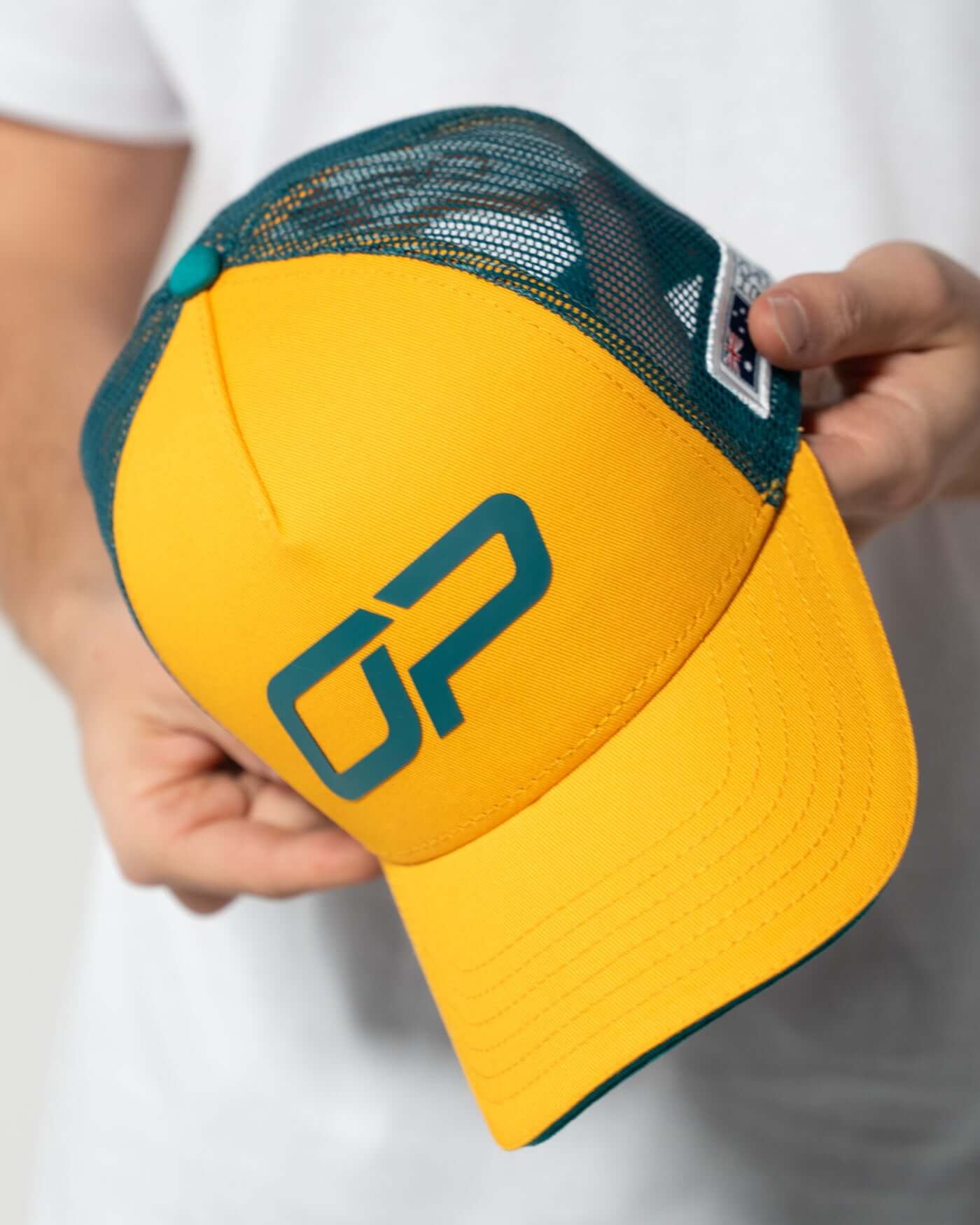 Home Race '26 Cap in bold green and gold colors with Oscar Piastri logo, lightweight and adjustable trucker cap.