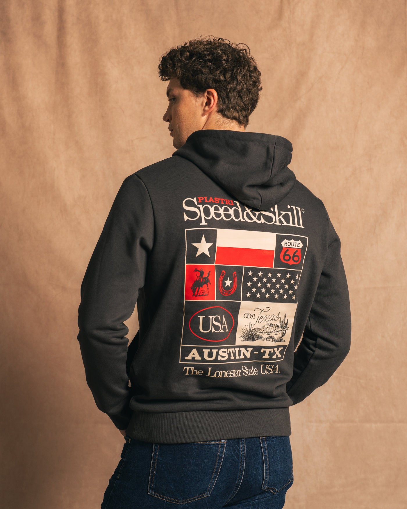 Texas 2024 Hoodie in Asphalt featuring Texas-inspired graphics and racing motifs from Circuit of the Americas (COTA), celebrating speed.