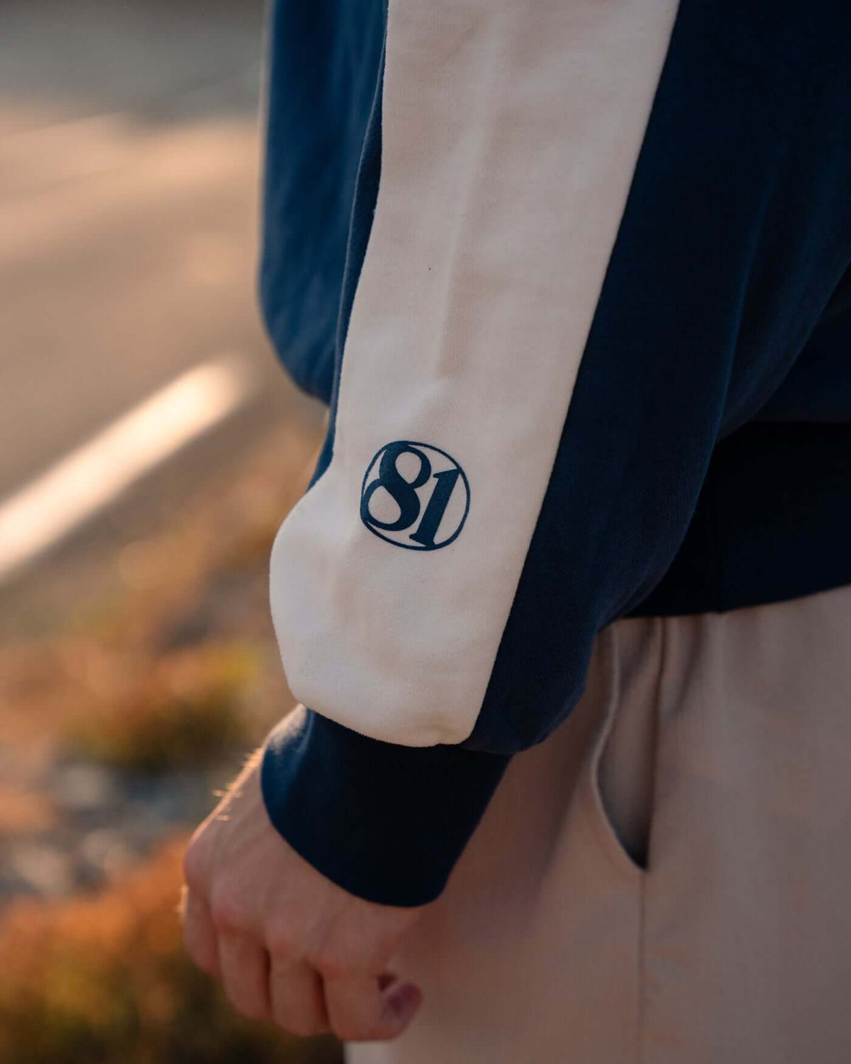 World Circuit Hoodie - Blue showing off-white racing panels and the globe emblem on the sleeve.