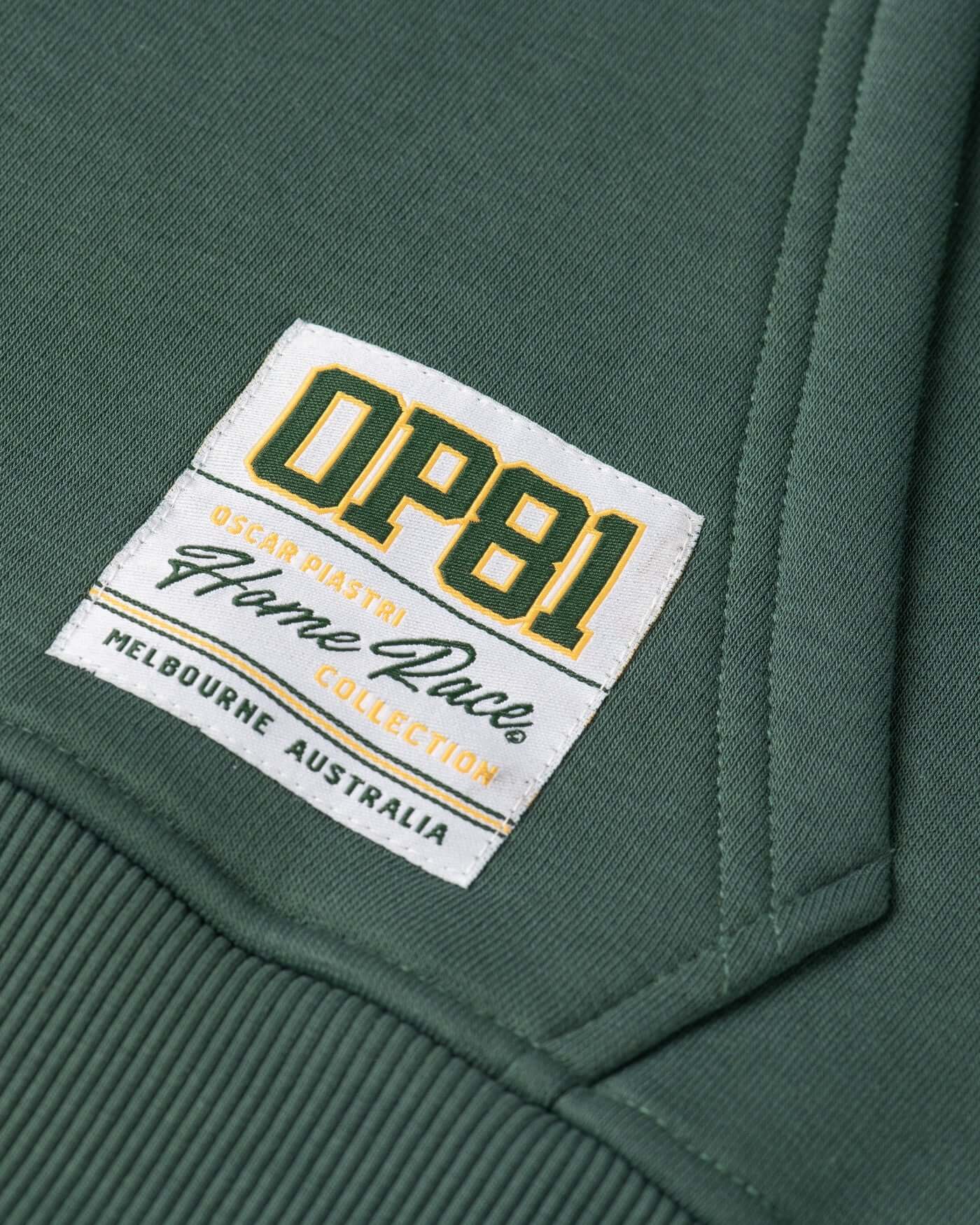 Close-up of the label on the green Home Race Hoodie, featuring the Oscar Piastri Flame Race Collection design.