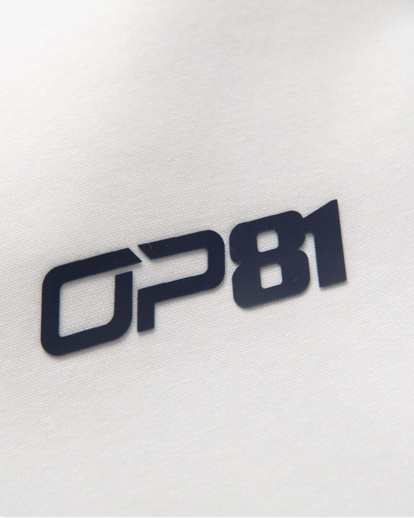 OP81 logo patch featured on Signature Joggers - Off White, adding a stylish touch to casual wear.