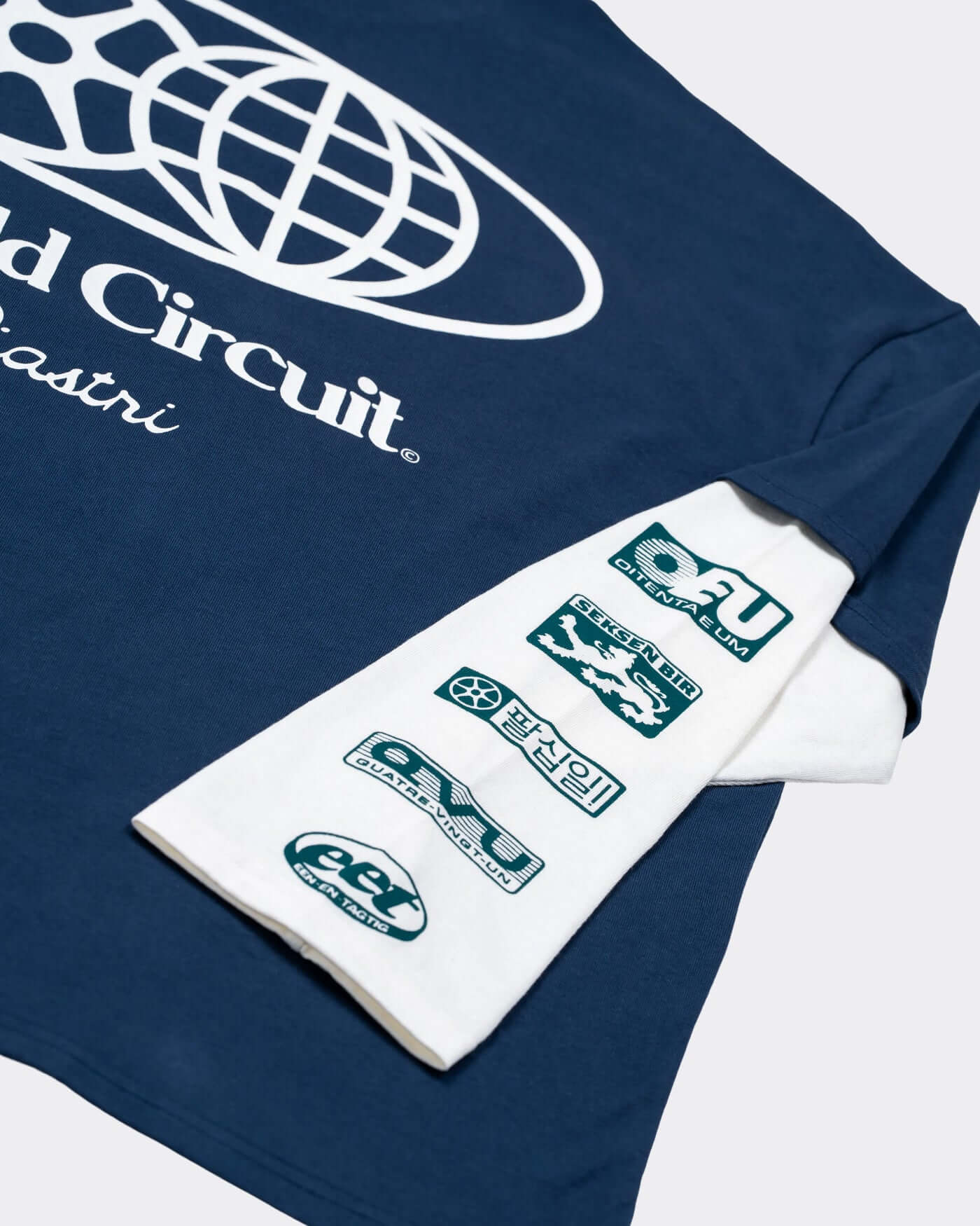 World Circuit Layered T-Shirt - Blue close-up of blue short sleeve with off-white layered sleeves and sponsor graphics.