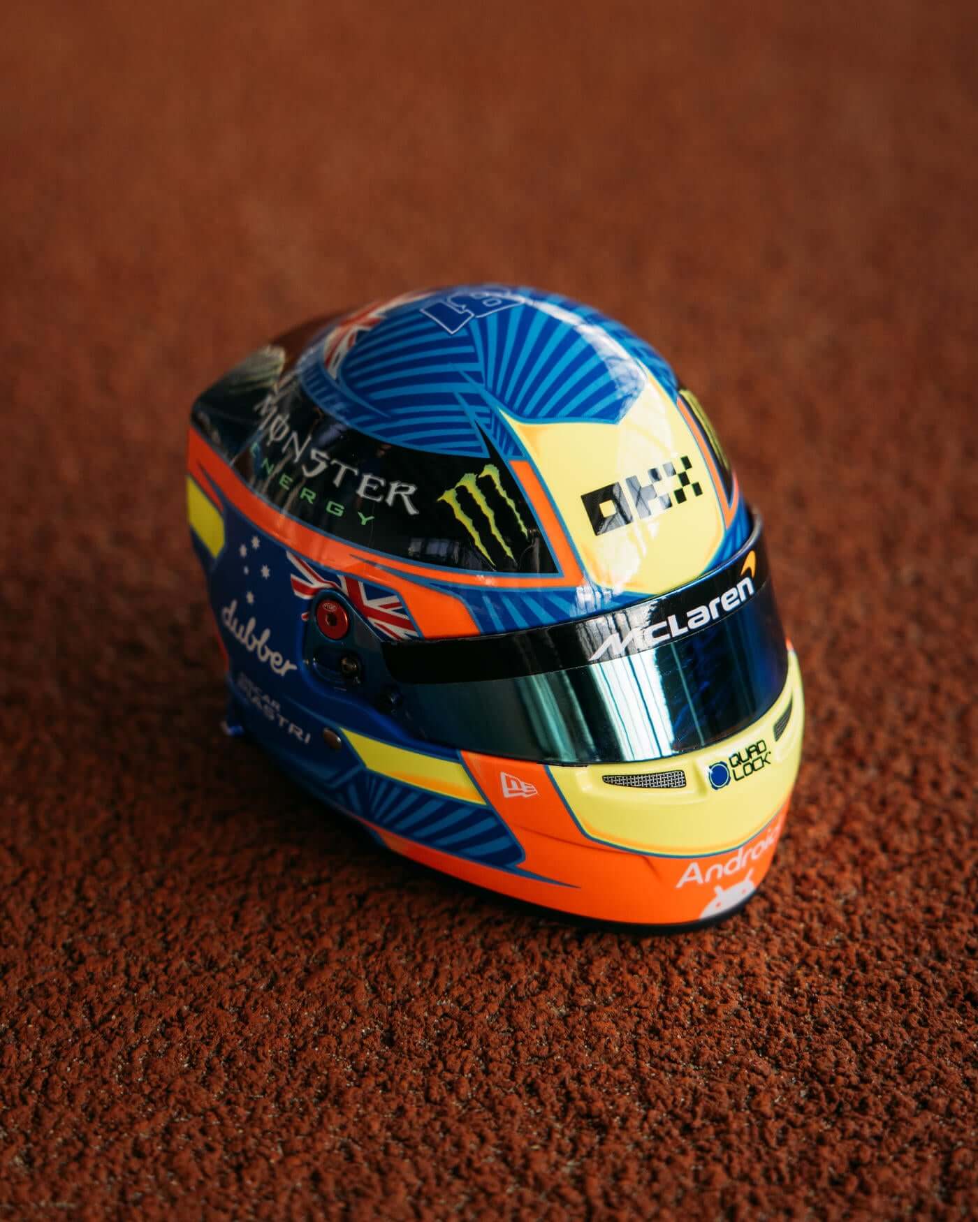 1:2 scale 2024 Season mini helmet with Oscar Piastri's distinctive red, blue, and yellow design and racing number.