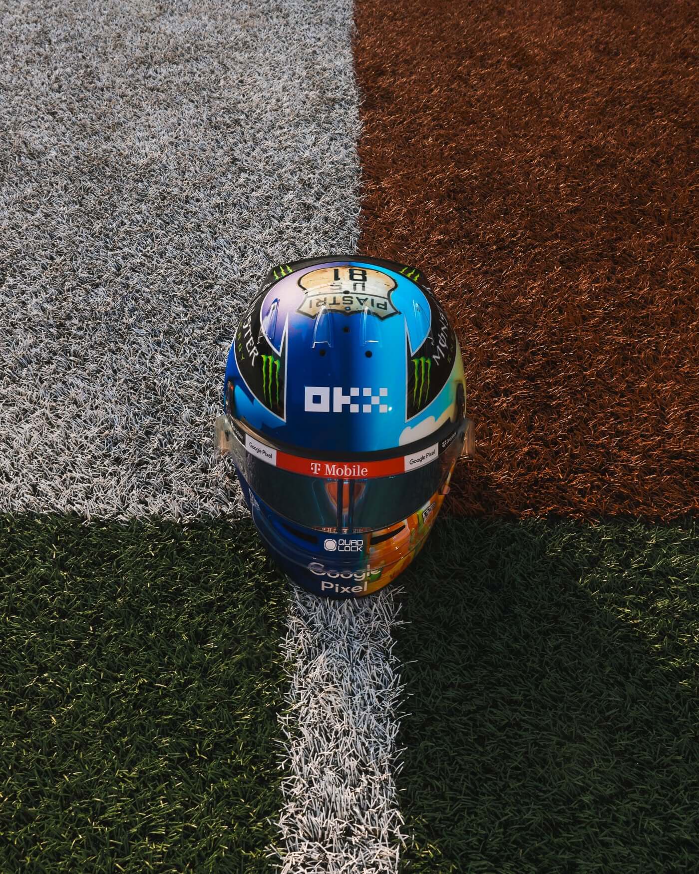 1:2 scale 2024 US Helmet - Oscar Piastri replica on grass, showcasing vibrant design and detailed features for F1 fans.