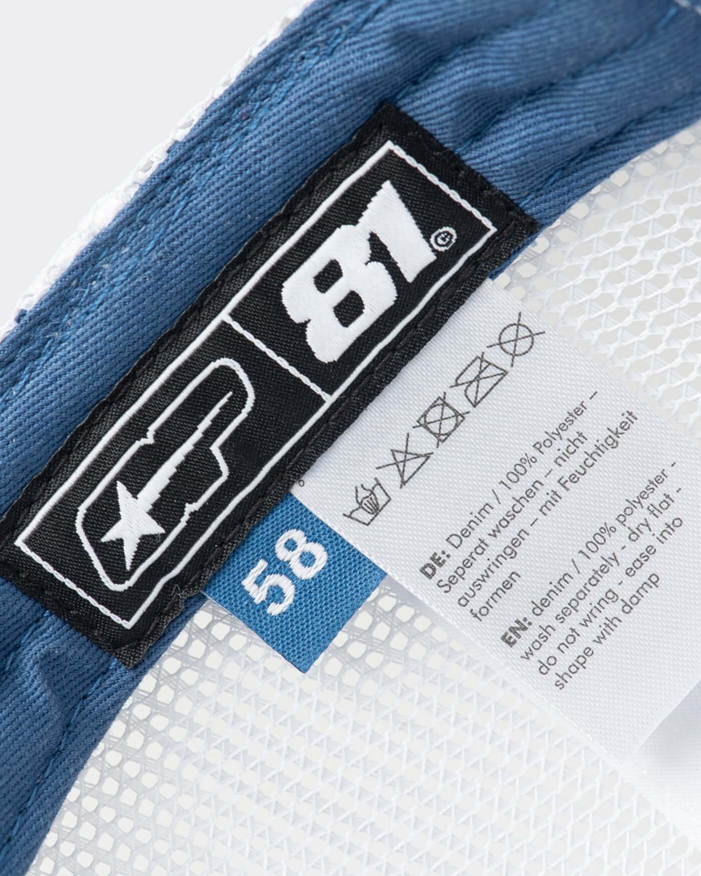 Inside view of the Origins Cap showing the size label and breathable mesh detailing.