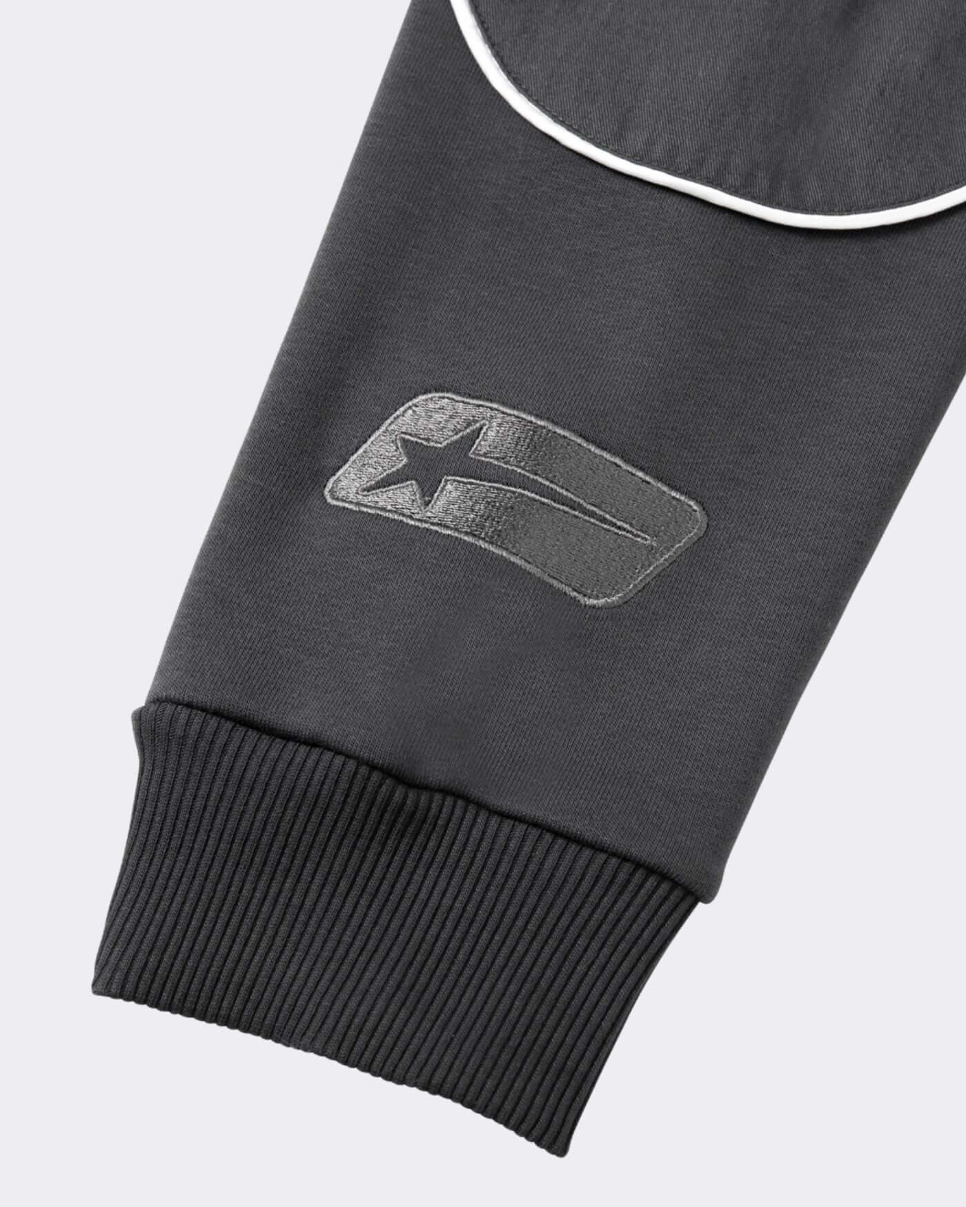 Close-up of the OP81 Origins Hoodie - Asphalt showing bold logo detail on sleeve.