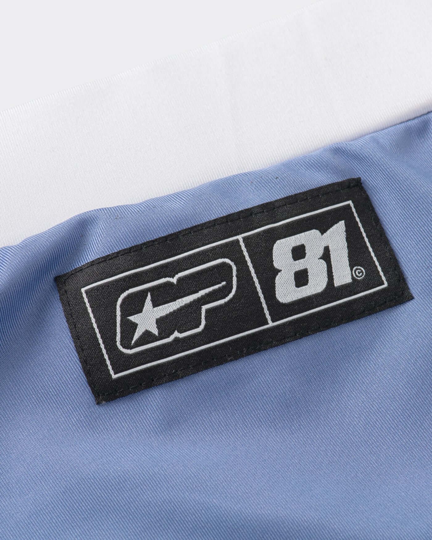 Close-up of the label on Origins Joggers featuring logo and size information.