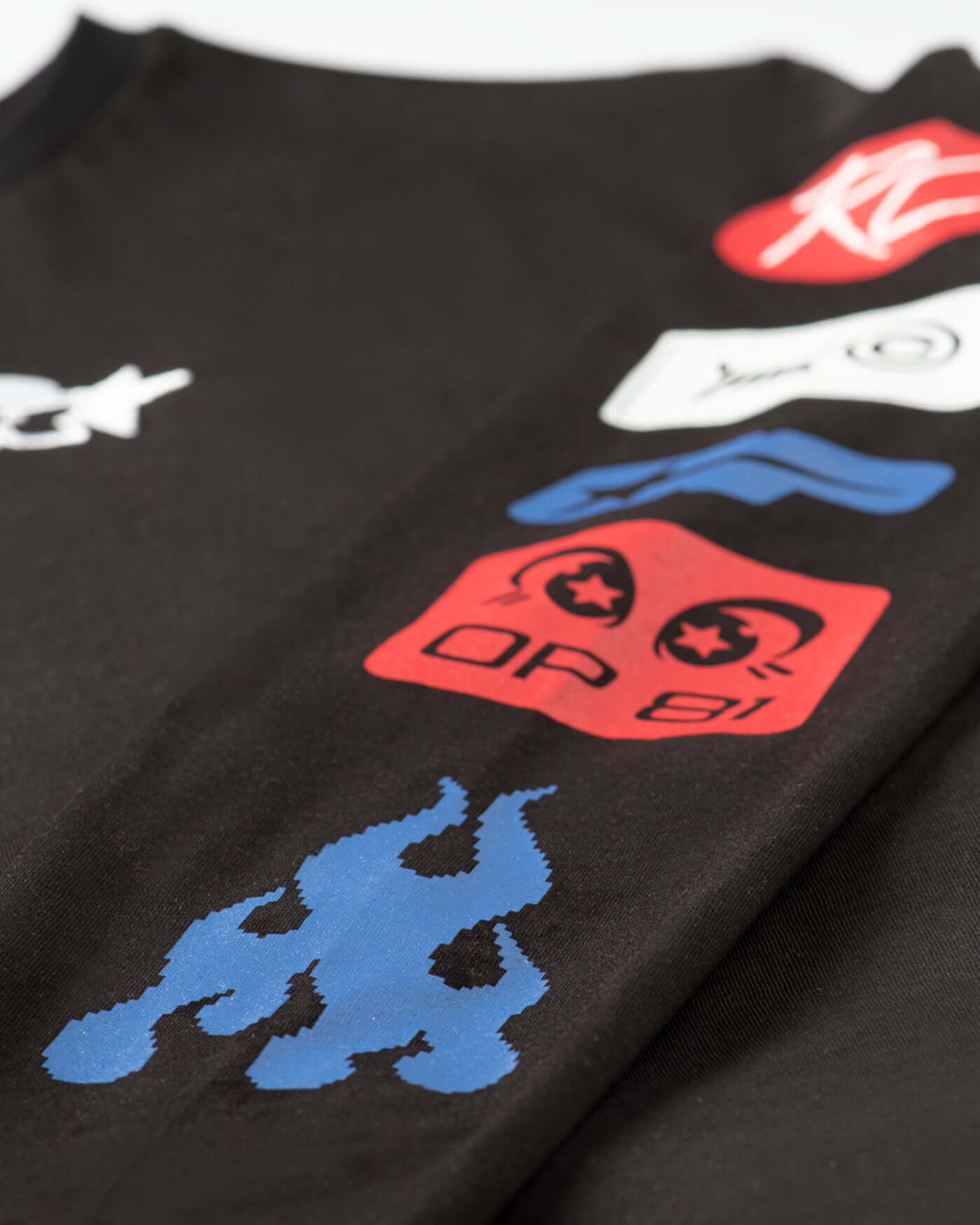 Close-up of sleeve graphic design on Origins Long Sleeve T-Shirt - Black with bold prints and vibrant colors.