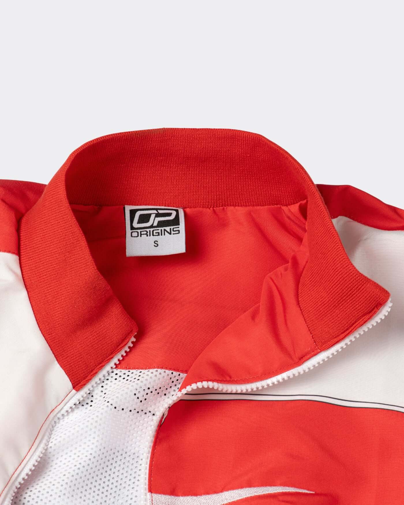 Close-up of the collar and tag of the Origins Race Jacket, showcasing retro motorsport style details.