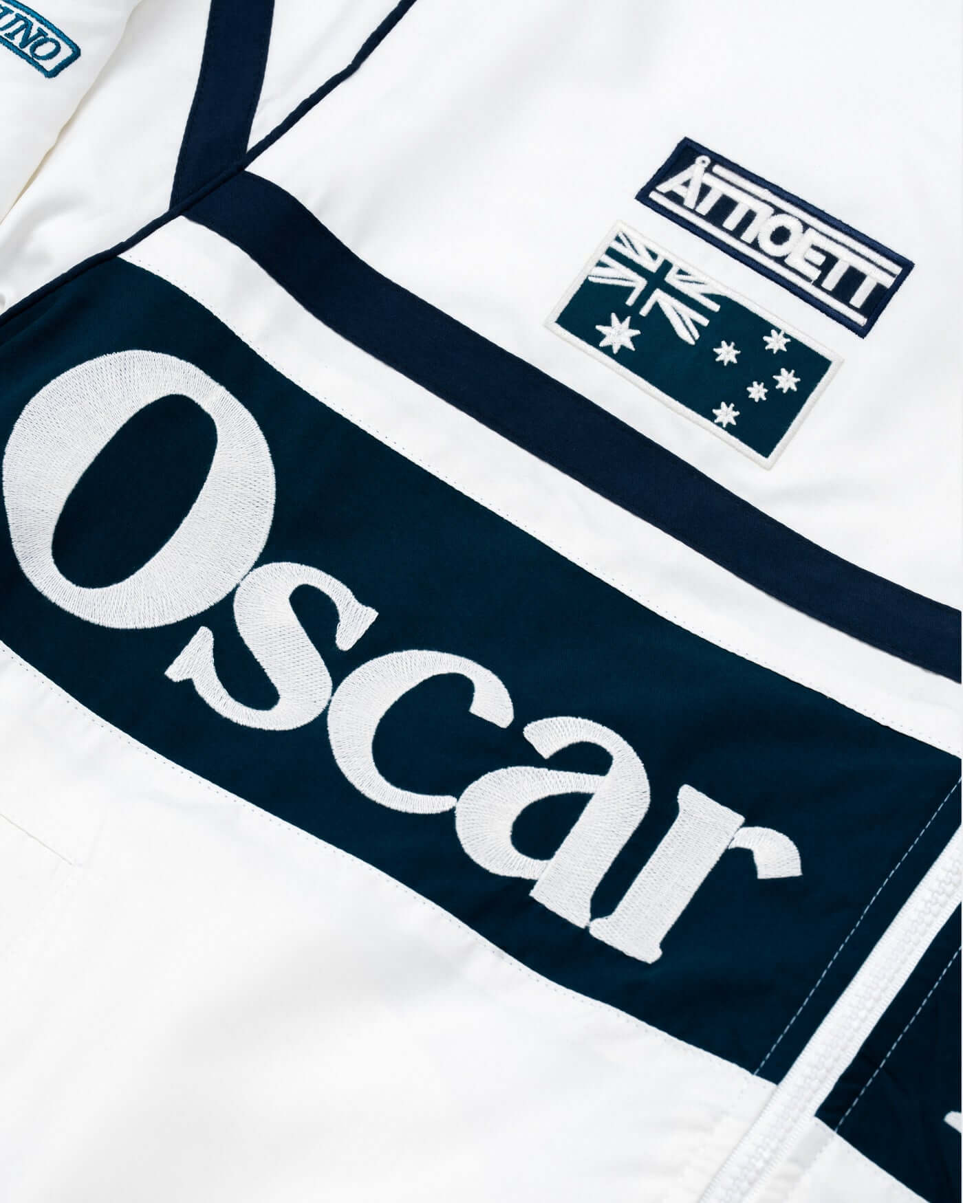 Close-up of the World Circuit Race Jacket featuring embroidered 'Oscar' and Australian flag details.