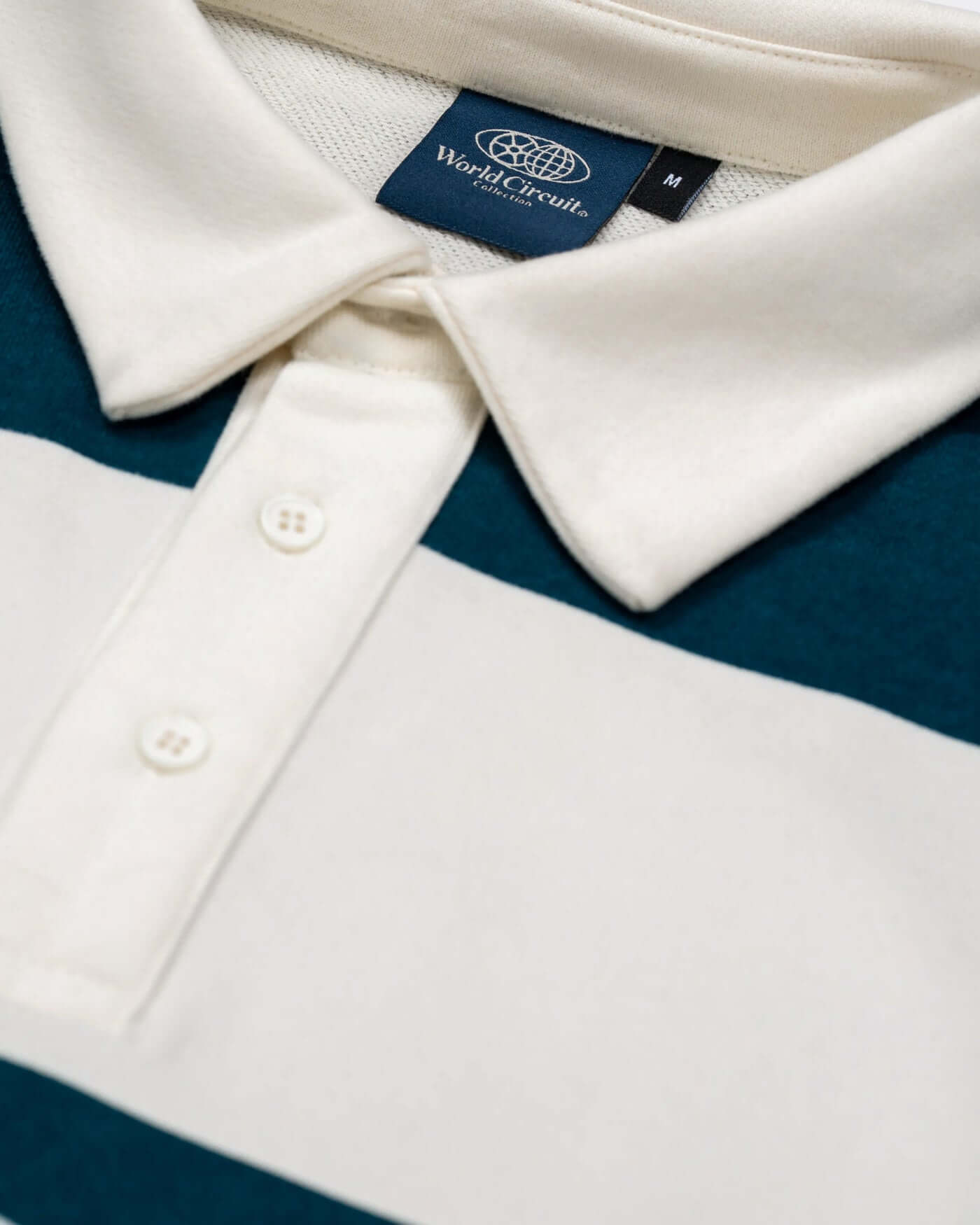 Close-up of the collar and tag of the World Circuit Rugby Shirt in green and off-white stripes.