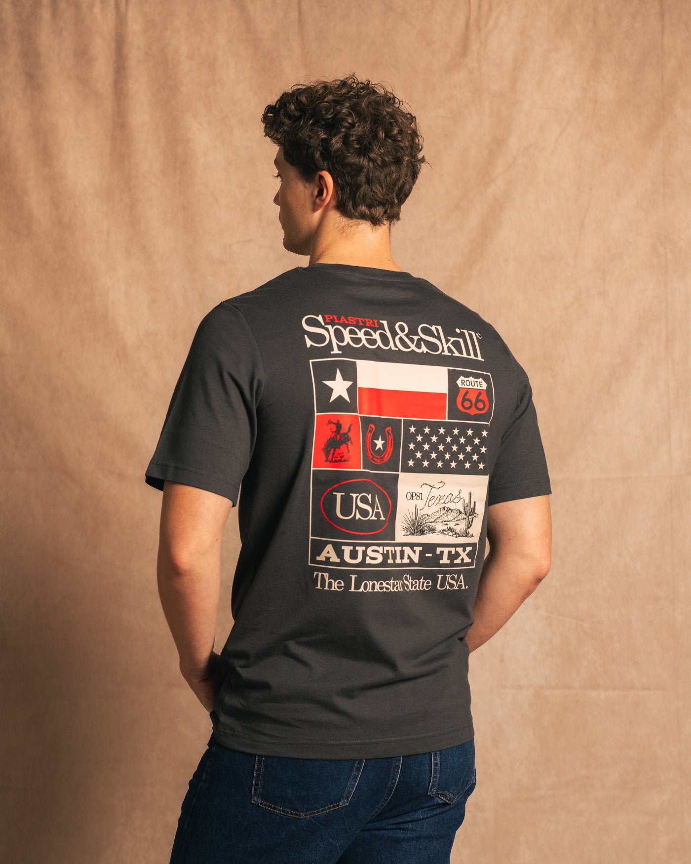 Man wearing Texas 2024 T-Shirt in Asphalt with Texas-inspired graphics and racing theme, celebrating speed and skill.