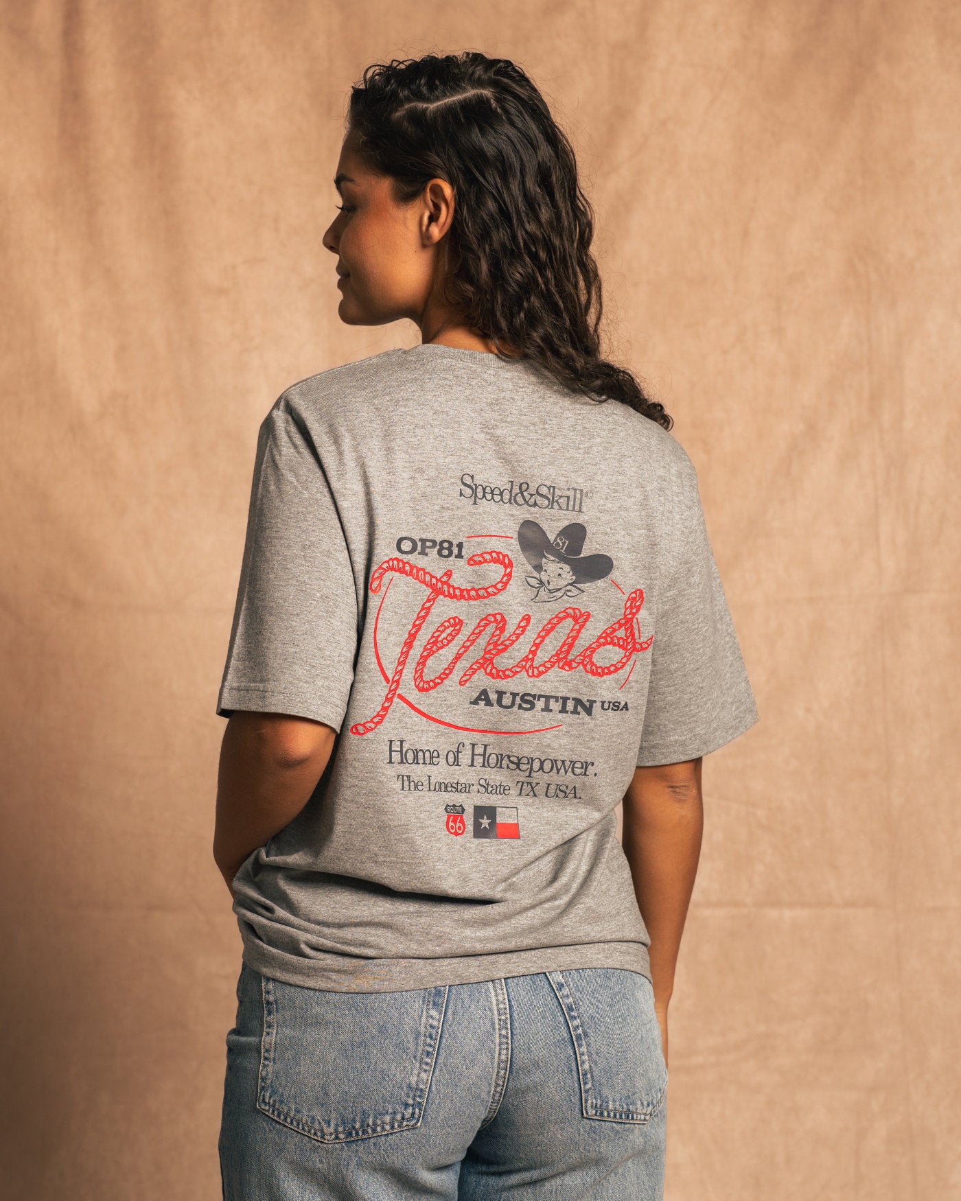 "Back view of Texas 2024 T-Shirt in Light Grey with bold Texas-inspired graphics, celebrating Formula 1 and Western culture fusion."
