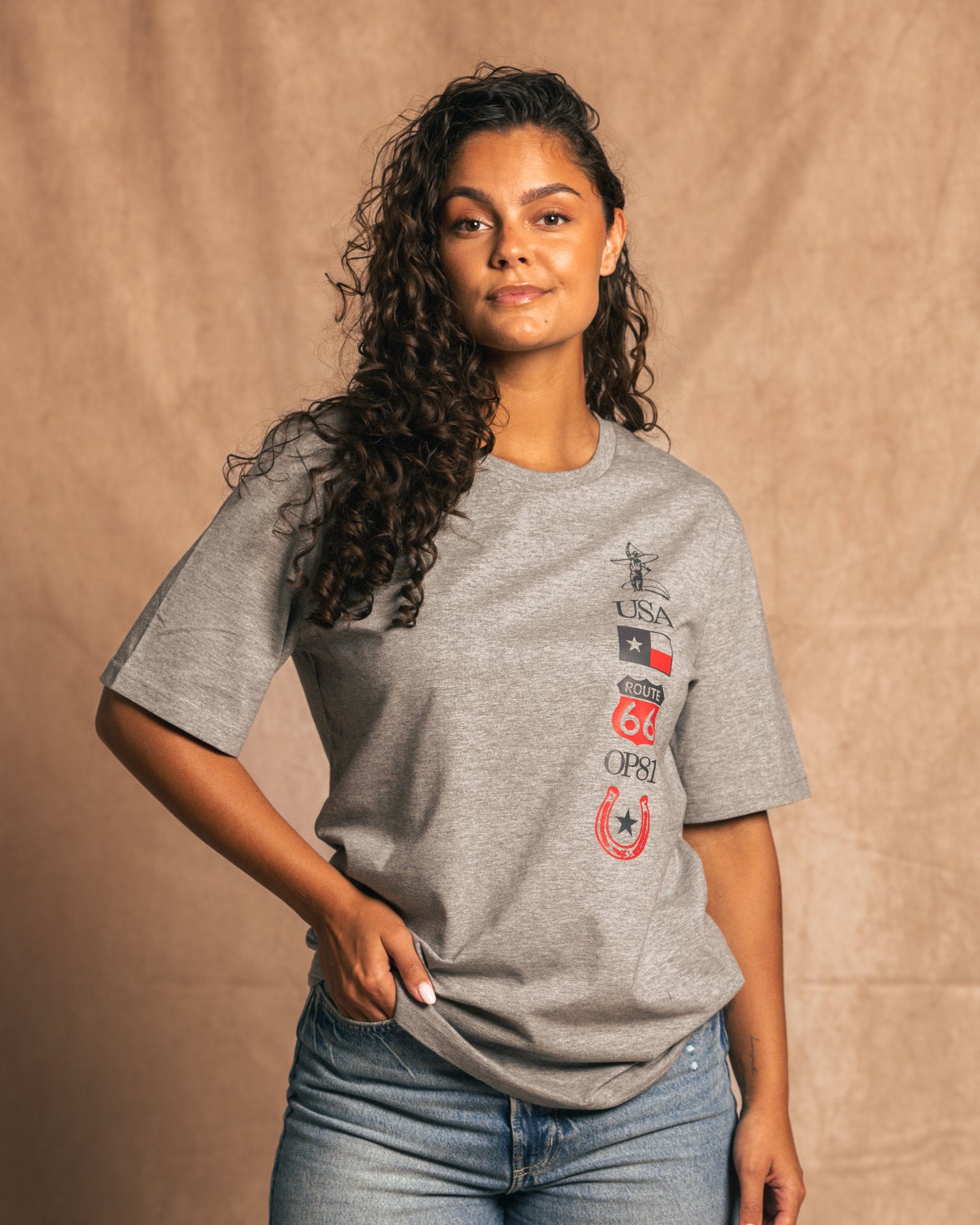 Person wearing Texas 2024 T-Shirt in light grey with Texas-inspired graphics, inspired by Circuit of the Americas and racing style.