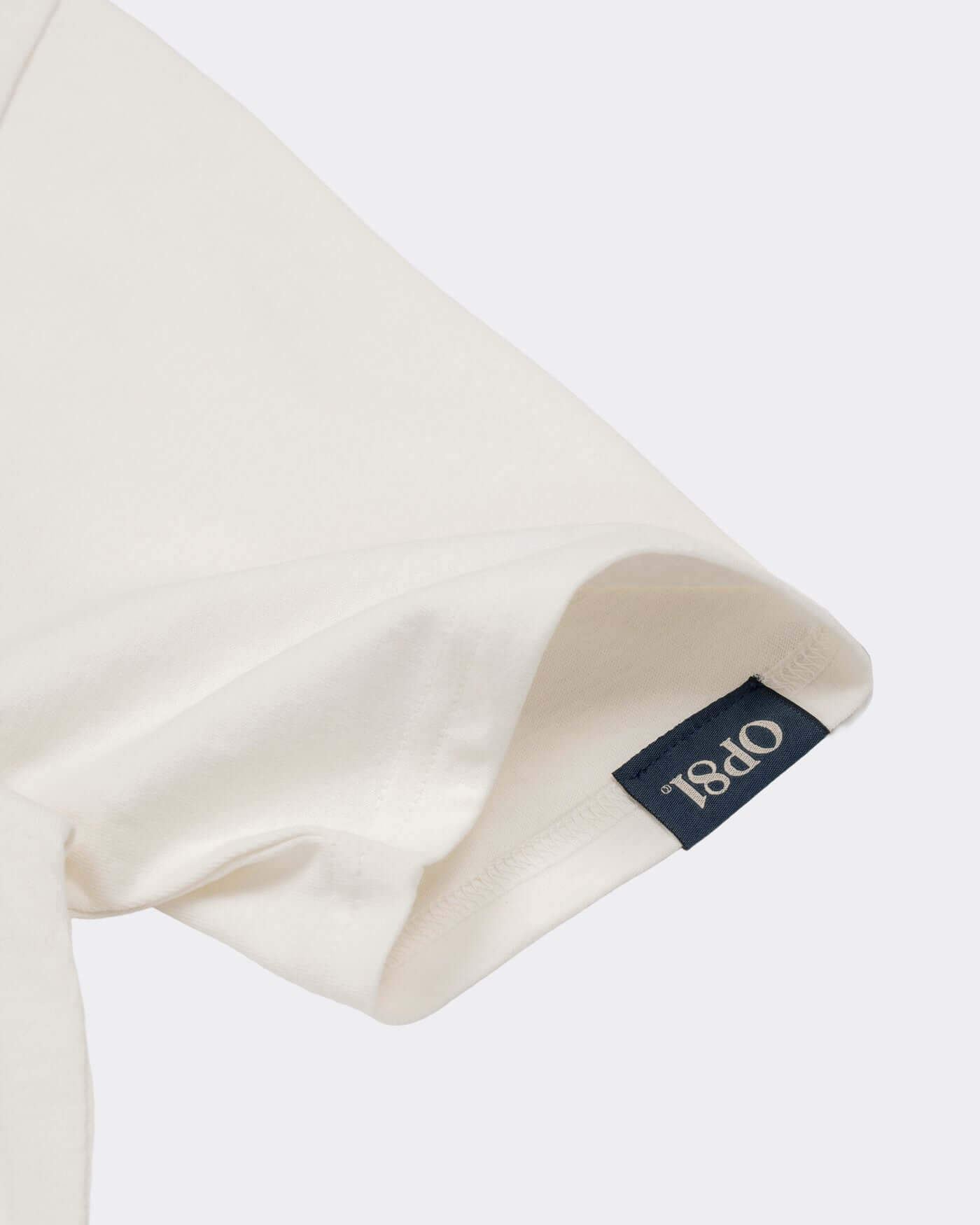 World Circuit T-Shirt - Off White close-up showing sleeve and brand label detail.