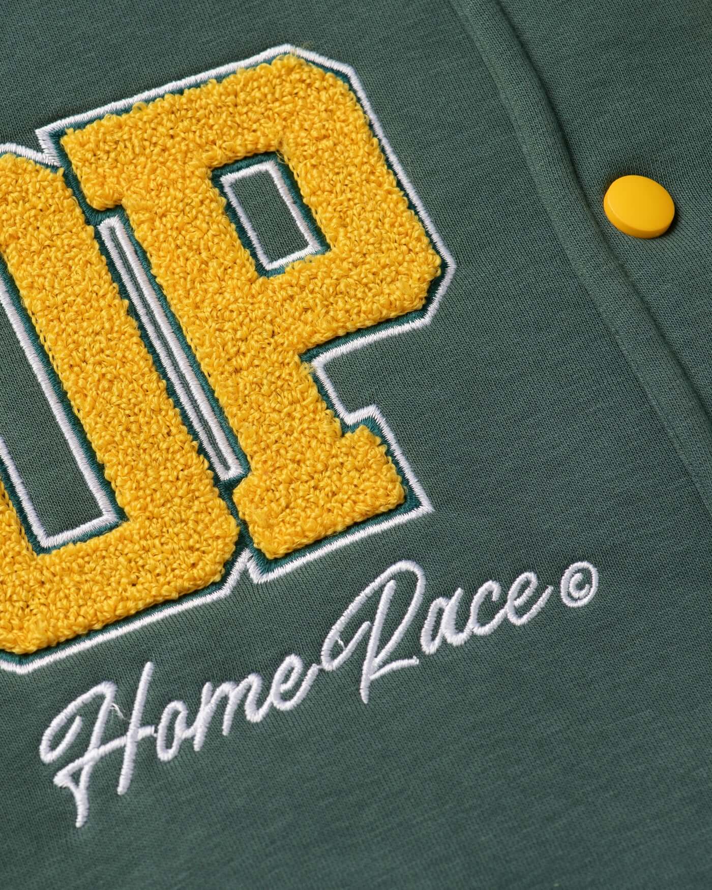 Close-up of the Home Race Varsity Jacket featuring chenille embroidery and vibrant yellow letters.