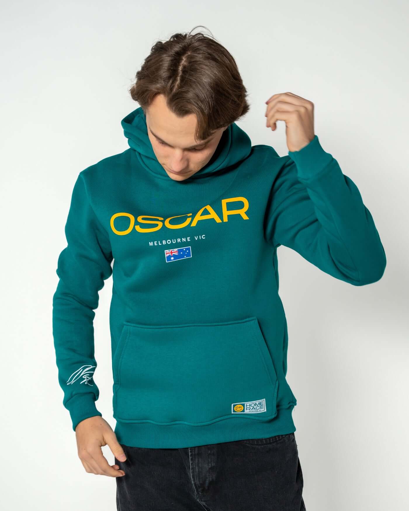Home Race '26 Hoodie - Green worn by Oscar showing the cozy design and kangaroo pocket.