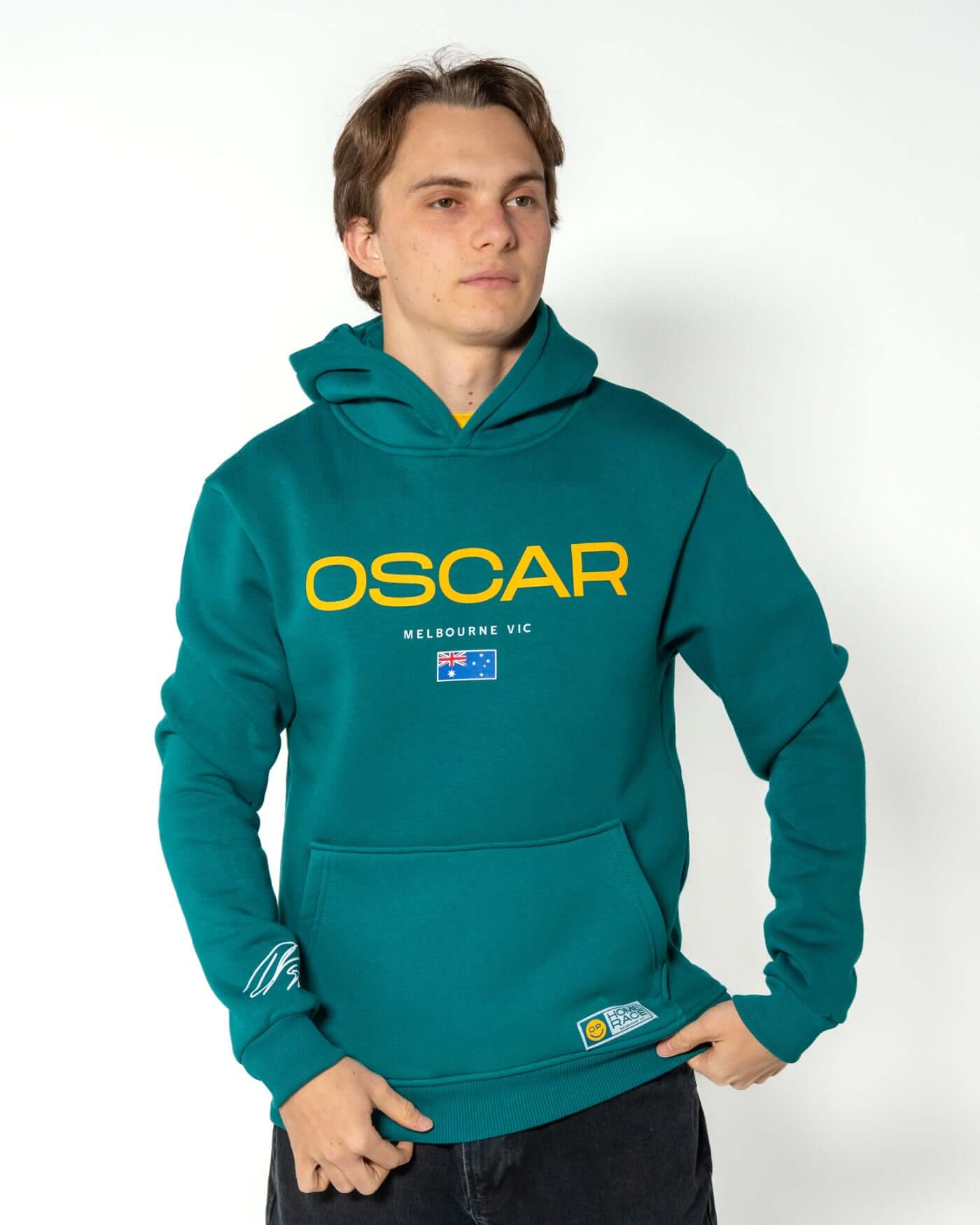 Home Race '26 Hoodie - Green worn by Oscar, showcasing Aussie pride and stylish design for cool days.
