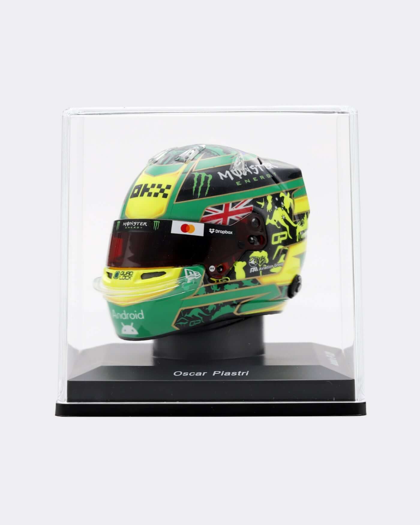 1:5 scale 2025 Australia Helmet - Oscar Piastri displayed in a protective case with vibrant green and yellow design.