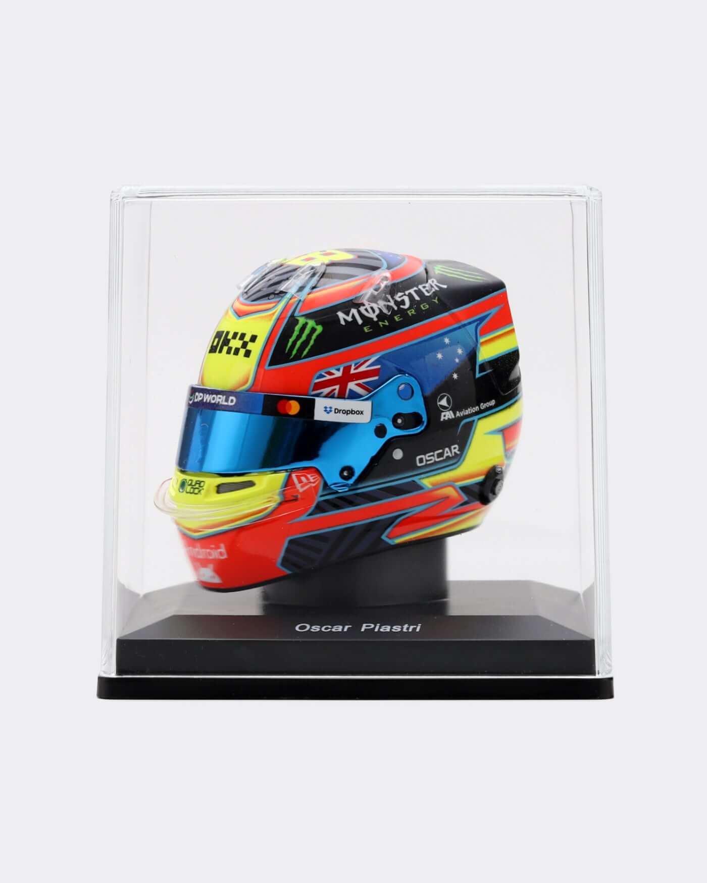 1:5 scale 2025 Season Helmet - Oscar Piastri displayed in a protective case showcasing vibrant design and personal logo.