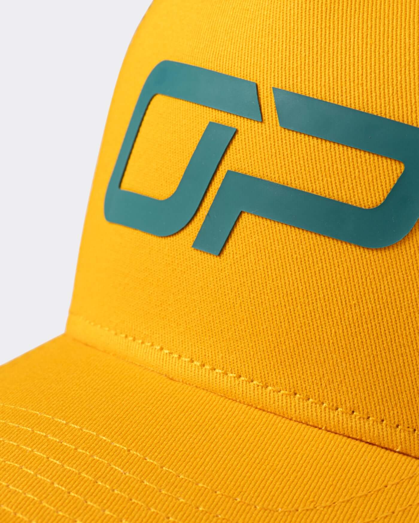 Detail of Home Race '26 Cap featuring bold yellow fabric and the green OP logo design.
