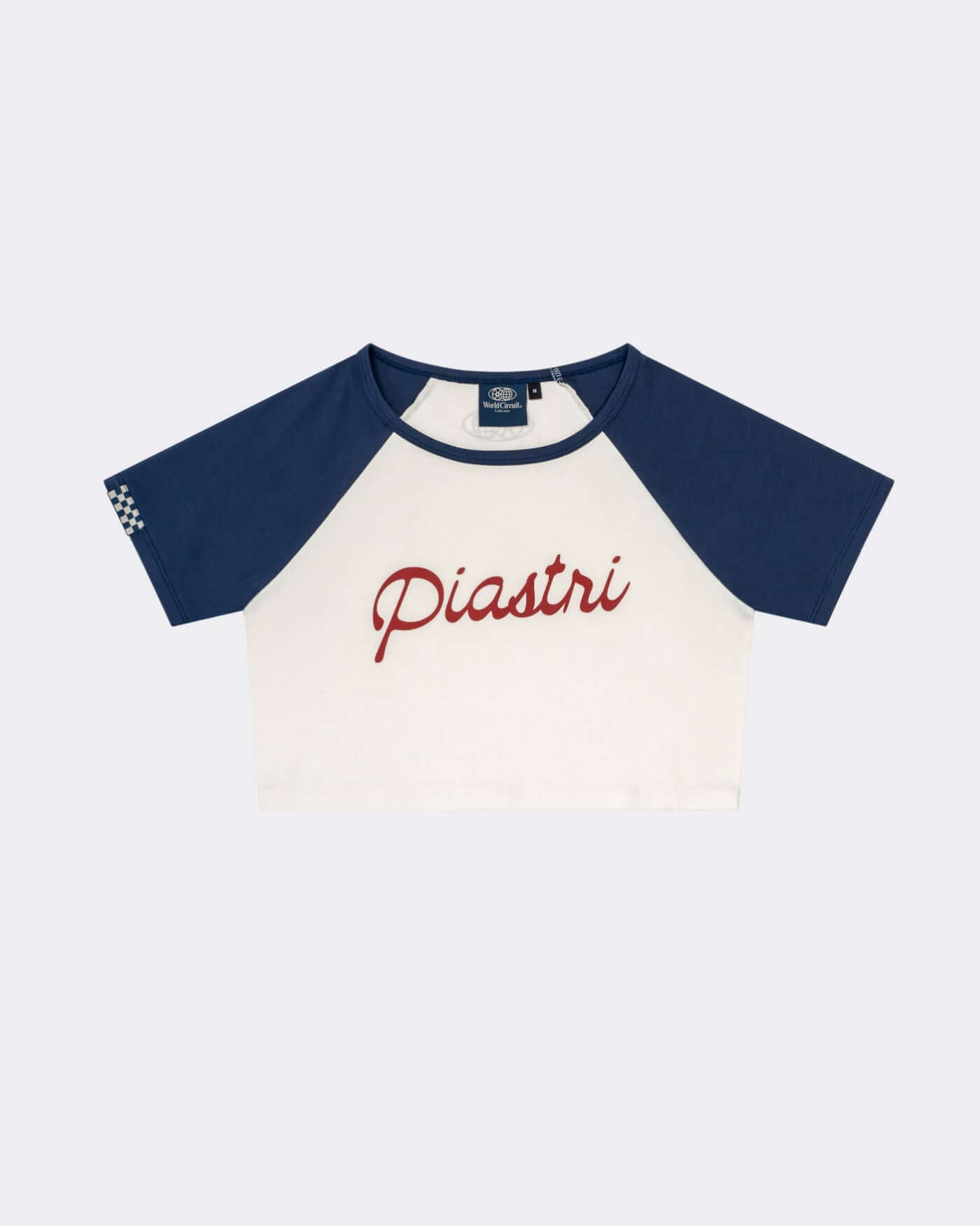 World Circuit Crop Tee featuring blue raglan sleeves and 'Piastri' script on an off-white body.