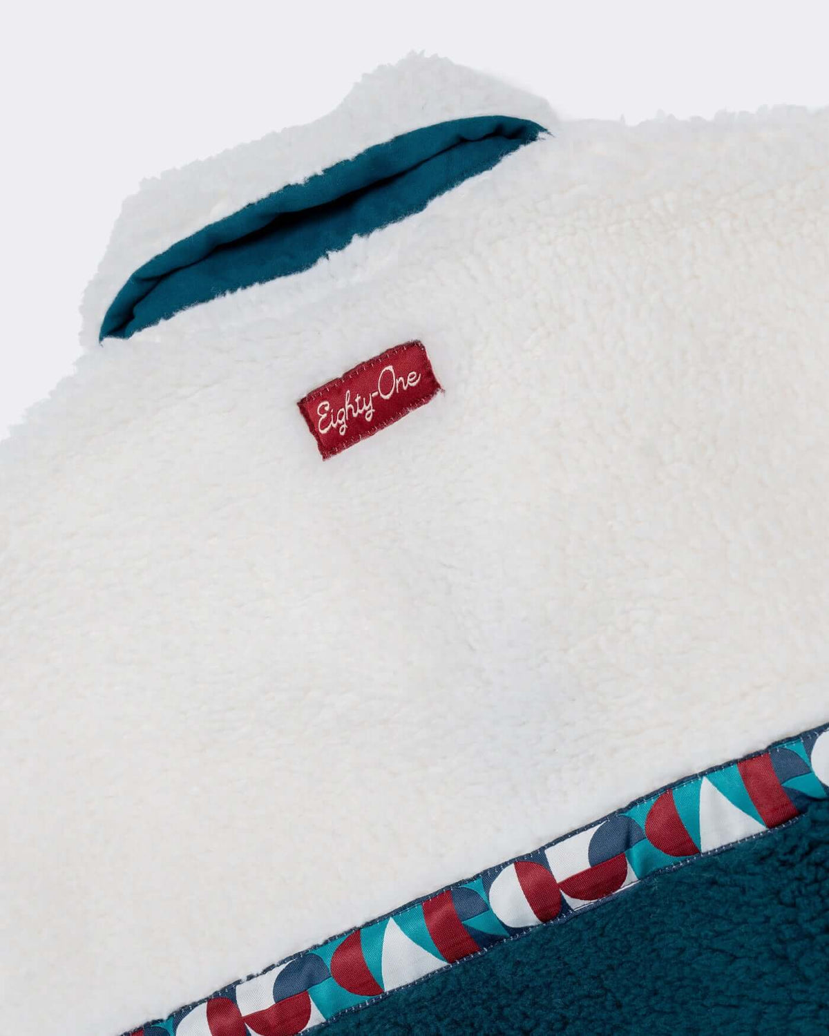 World Circuit Fleece detail with high stand collar, custom jacquard tape, and tag for a stylish cold-weather look.