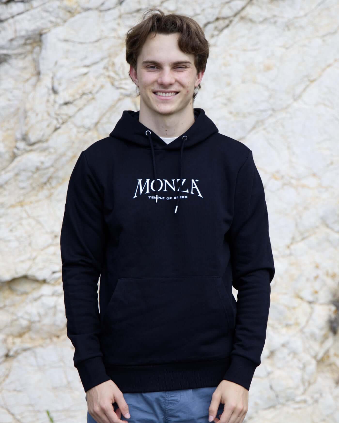 Oscar wearing black Monza Hoodie with kangaroo pocket, inspired by Italian Grand Prix at Temple of Speed. Cozy unisex design.