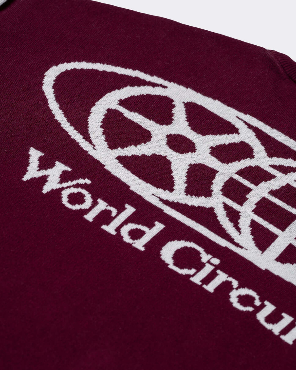 World Circuit Knitted Sweater - Burgundy with jacquard emblem and script design on the front.