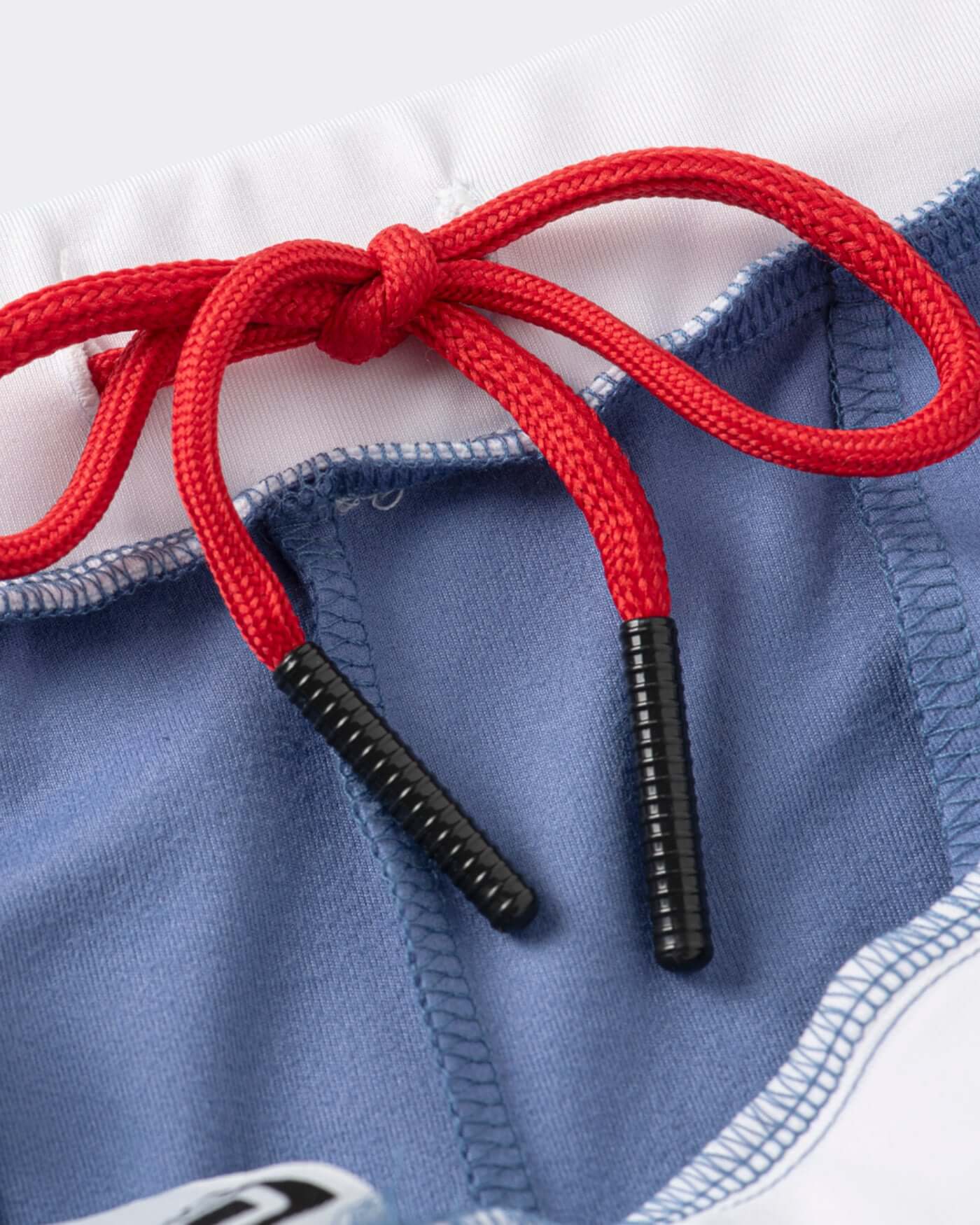 Close-up of red drawstring on Origins Joggers showcasing bold trims and modern details.
