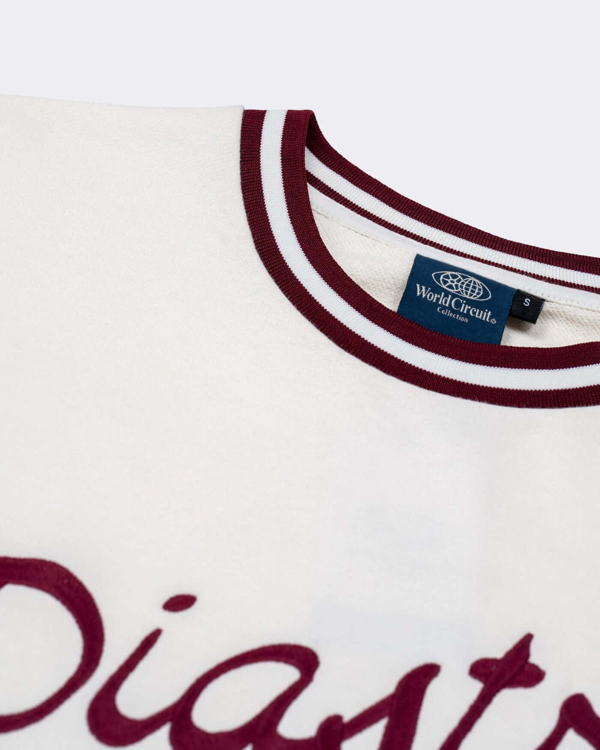 World Circuit Women's Sweater - Off White featuring burgundy embroidery and ribbed round neck.