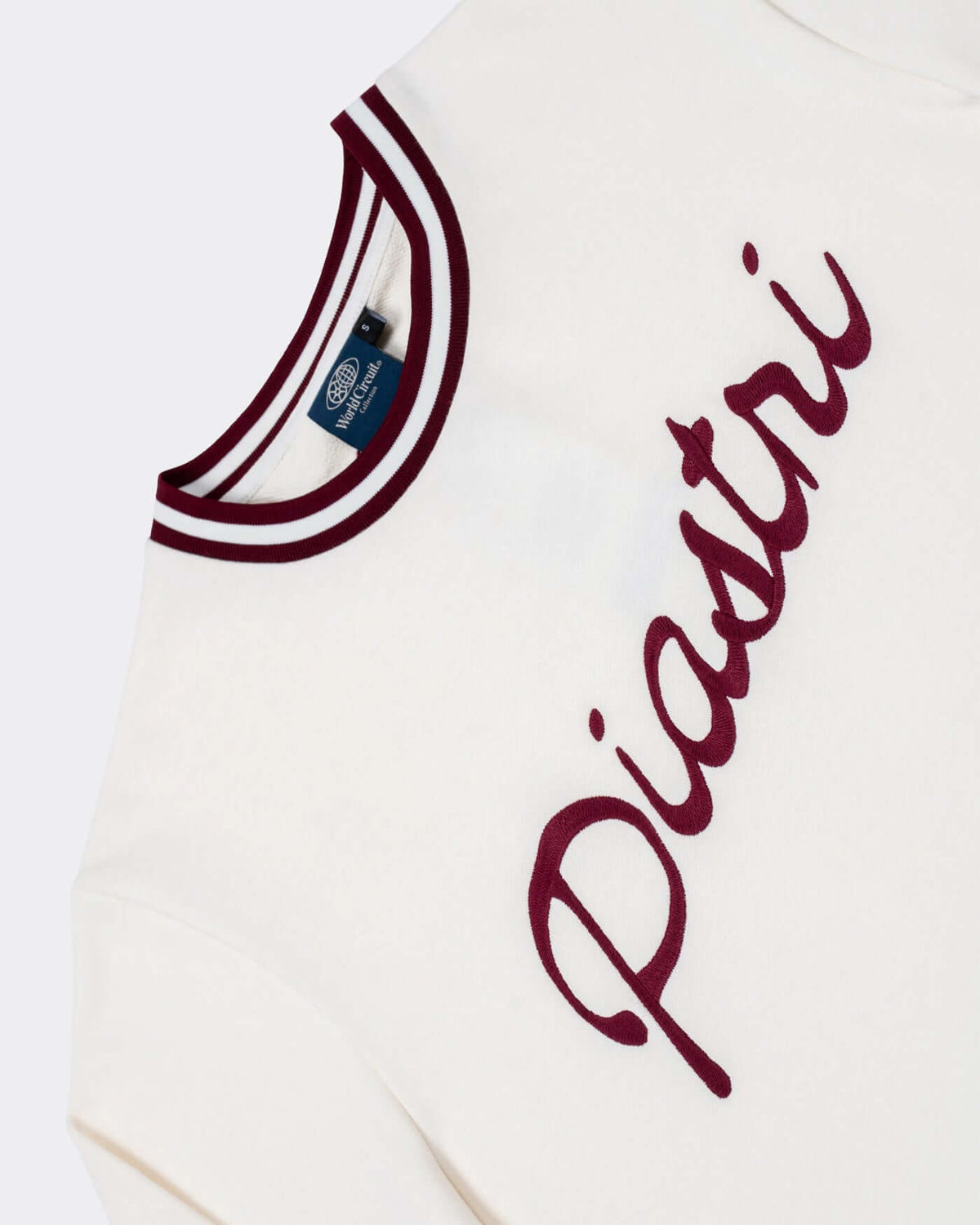 World Circuit Women's Sweater - Off White with burgundy Piastri embroidery and ribbed round neck.